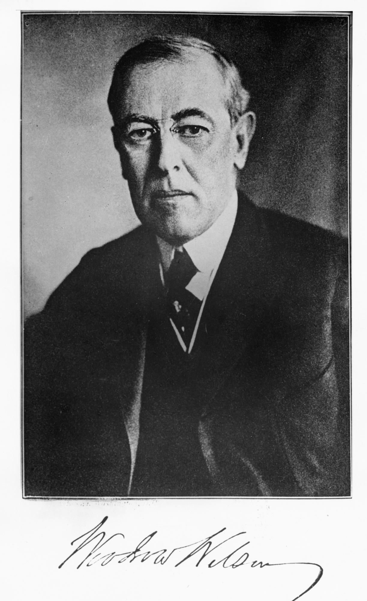 A portrait of former US president Woodrow Wilson. The photo is signed by him.