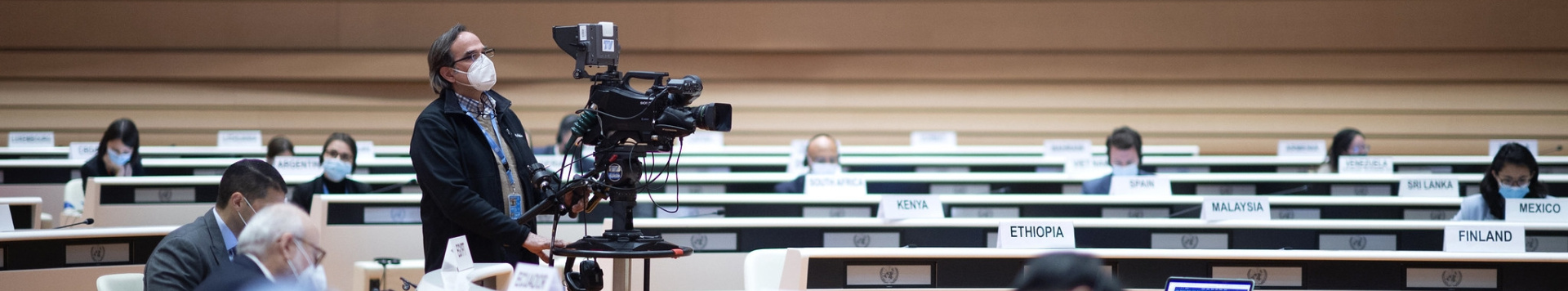 A camera man filming inside one of UN Geneva's conference rooms.