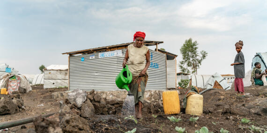 A woman tends to her cabbage crops in a small garden adjacent to her shelter within the Bulengo displacement site, DRC.jpg