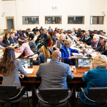 A meeting of NGO representatives with the President of the General Assembly, Dennis Francis, and UNOG Director General, Tatiana Valovaya, who are seen from behind addressing the audience. 