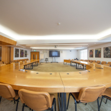 The large, u-shaped table inside Conference Room IV