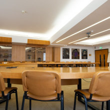 Room IV with its beige furniture and white, illuminated ceiling