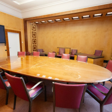A wide angle shot of table, TV and wall ornaments in Conference Room II