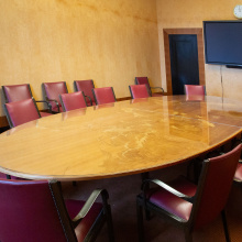 The seating arrangement in Conference Room II - a large oval table and 12 chairs