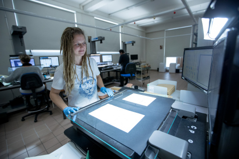 An employee scans documents from the League of Nations as part of the LONTAD digitization project. 