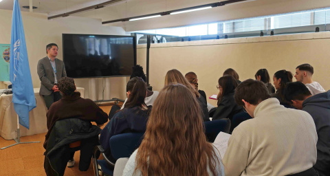 A students' group listening in to a meeting with an expert at the UN