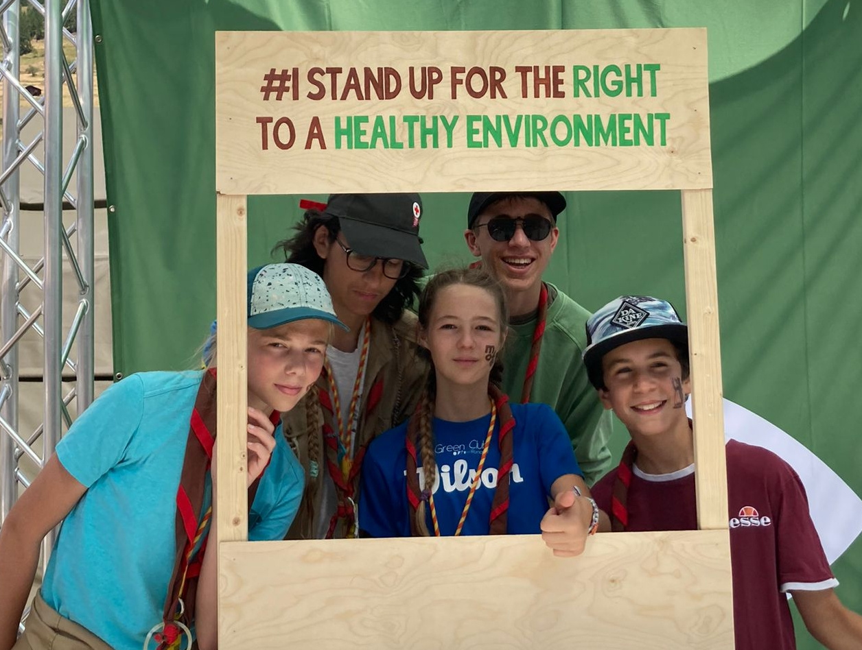 5 youths holding a frame that says "I stand up for the right to a healthy environment"