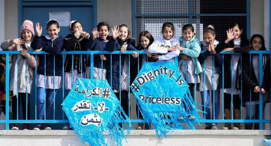 A group of Palestinian children celebrating the launch of UNRWA's Dignity is Priceless campaign.