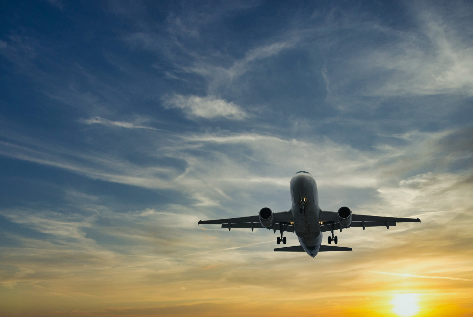 A plane flying through the evening sky.