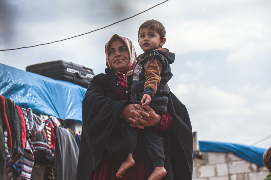  OCHA/Steve Hafez A widow holds her grandson in a displaced persons camp in northern Idleb Governorate, Syria.
