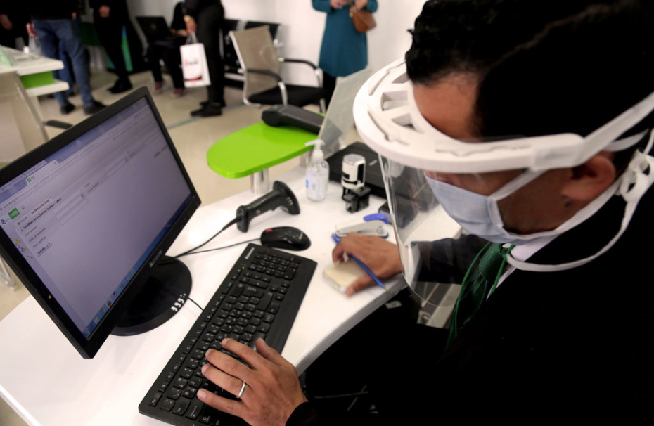 Photo OIT/Yacine Imadalou Un homme travaile à son ordinateur en Algérie en portant un masque en raison de la pandémie de Covid-19.