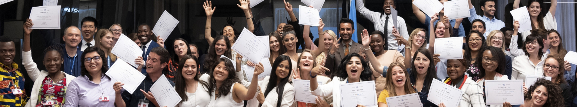 A group of students cheerfully showing their certificates
