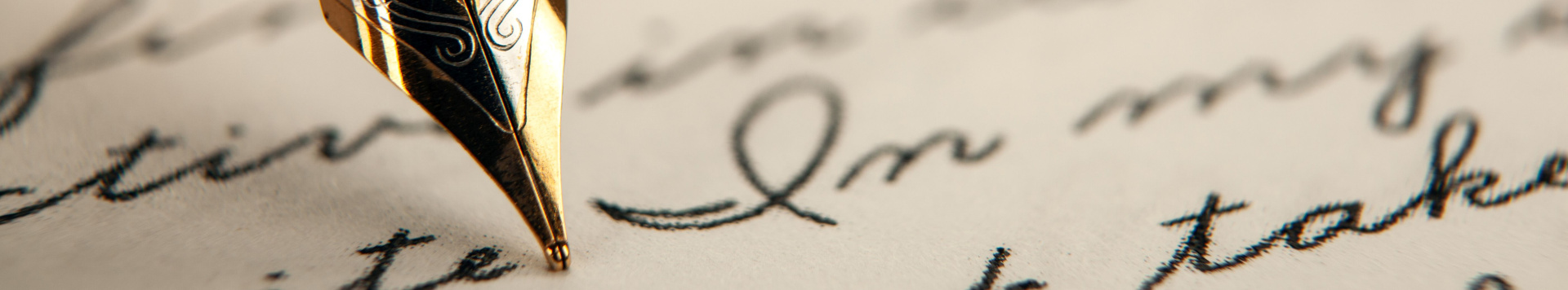A closeup of a pen, writing on a piece of paper. 