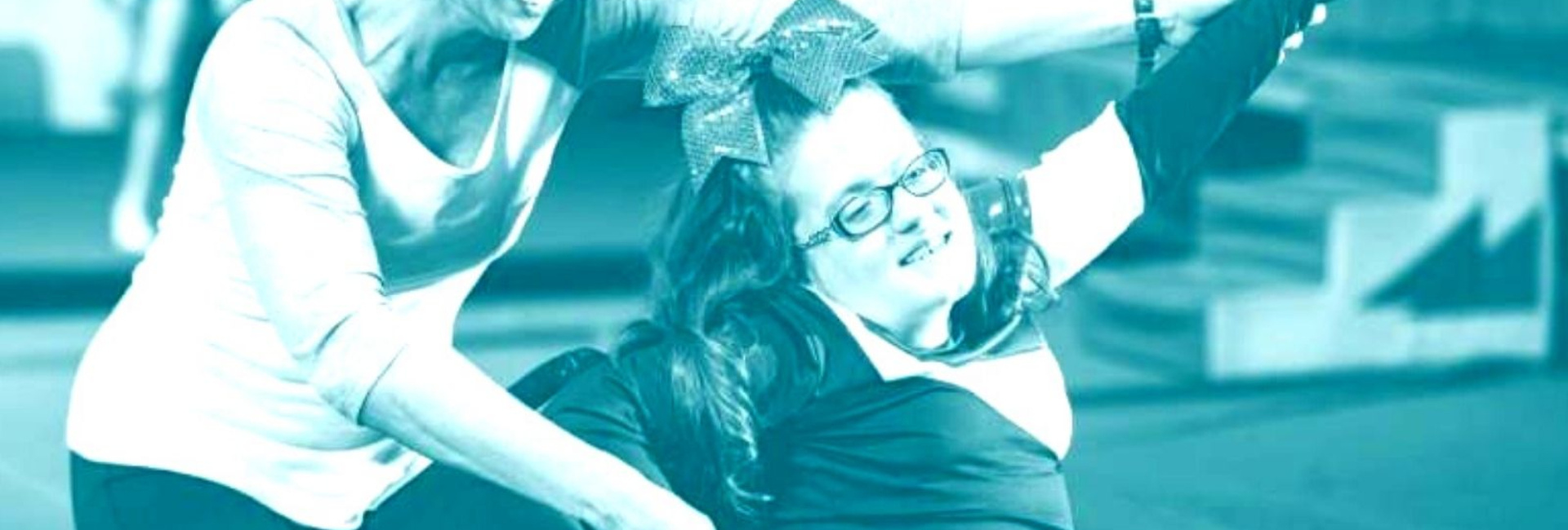 A girl in a wheelchair playing with her caregiver