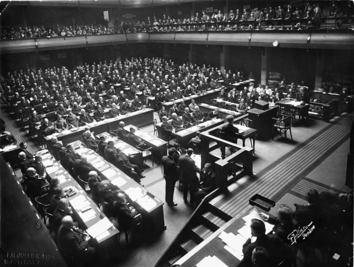 This black and white image from 1927 depicts a conference room full of delegates who are attending an international economic conference