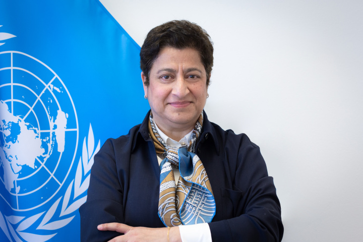 Rima Al-Chikh DCM Director photo with UN flag